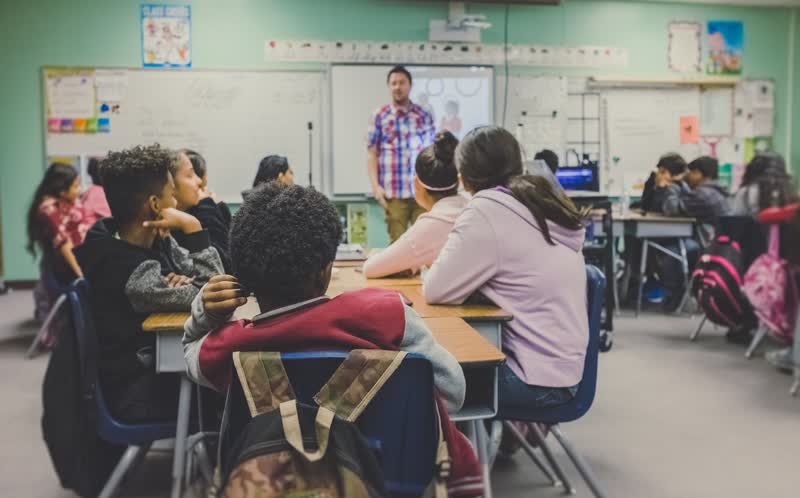 Learners and a teacher engaged in hands-on instruction — authorship in practice